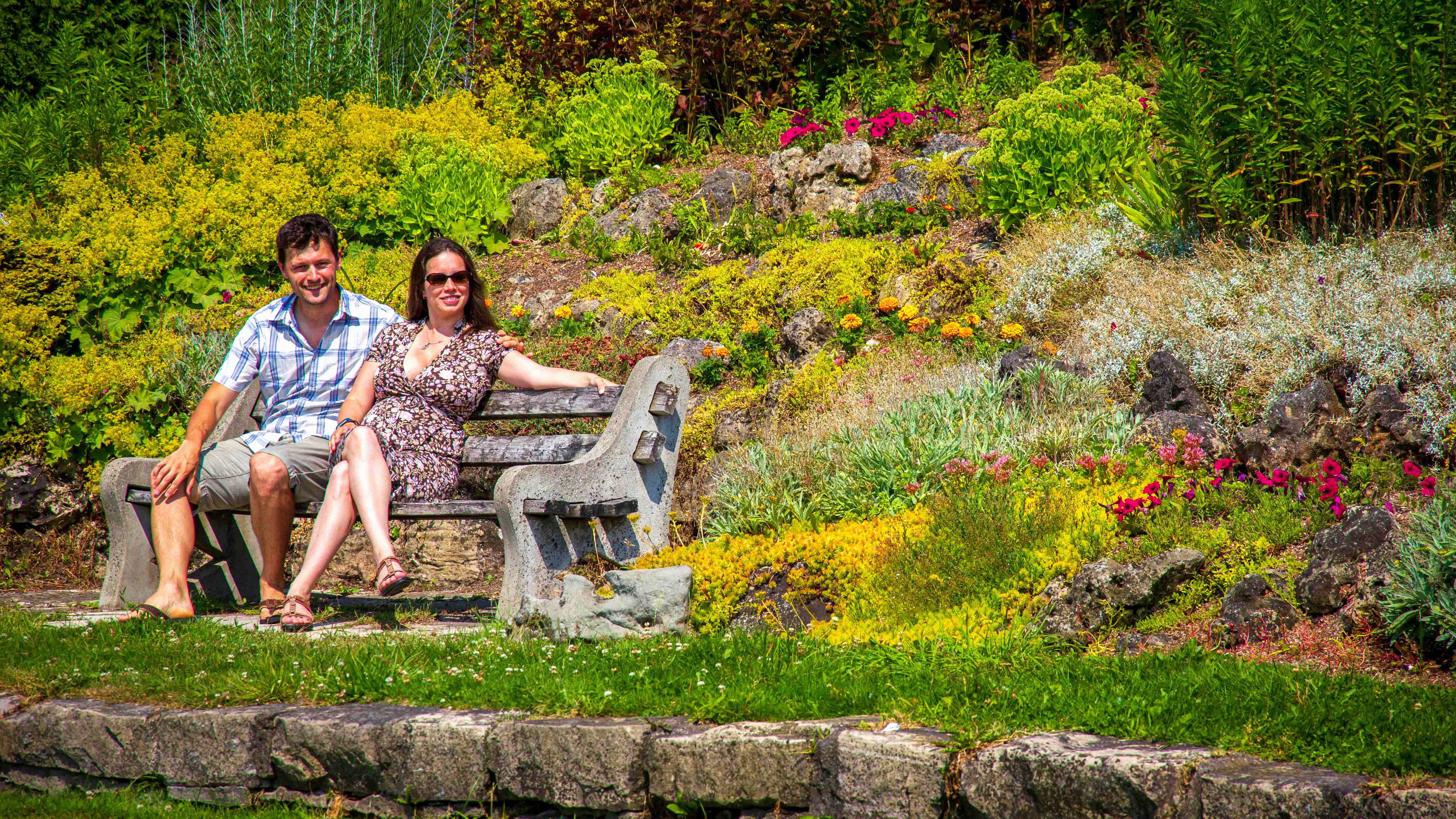 A couple sit on a bench in Kincardine's Rock Garden.